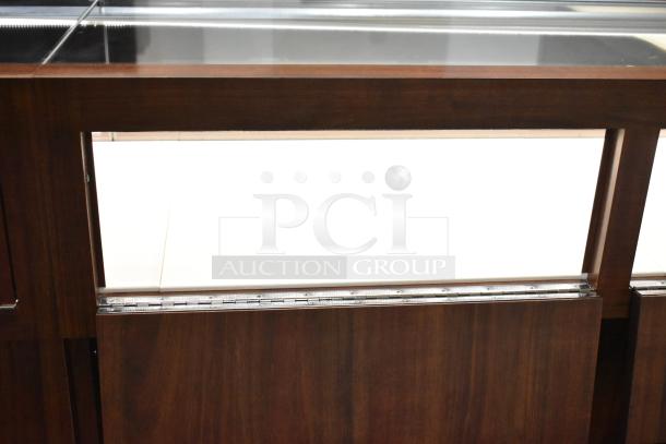 Lighted wooden jewelry display case, glass top, dark wood finish, pristine condition. Ideal for showcasing merchandise.