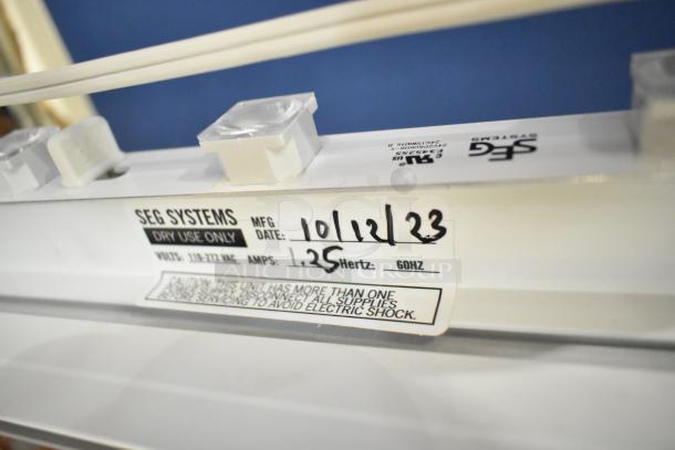 SEG Systems wall mount lighted picture mount, 110-277V, MFG date 10/12/23, amperage 1.25, Hertz 60.