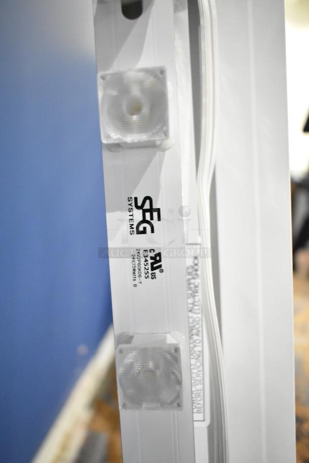 SEG Systems wall mount lighted picture frame, 110-277 volts, featuring visible LED lights and manufacturer label.