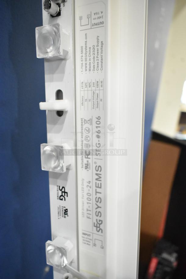 SEG Systems Wall Mount Lighted Picture Mount, SEG-6106, white. 110-277V, suitable for indoor use, detailed labeling visible.