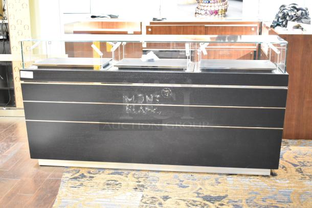 Black jewelry case with glass top, featuring six rear drawers. Montblanc logo on front. Buyers need tools for removal.