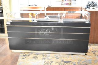 Black jewelry case with glass top, featuring six rear drawers. Montblanc logo on front. Buyers need tools for removal.
