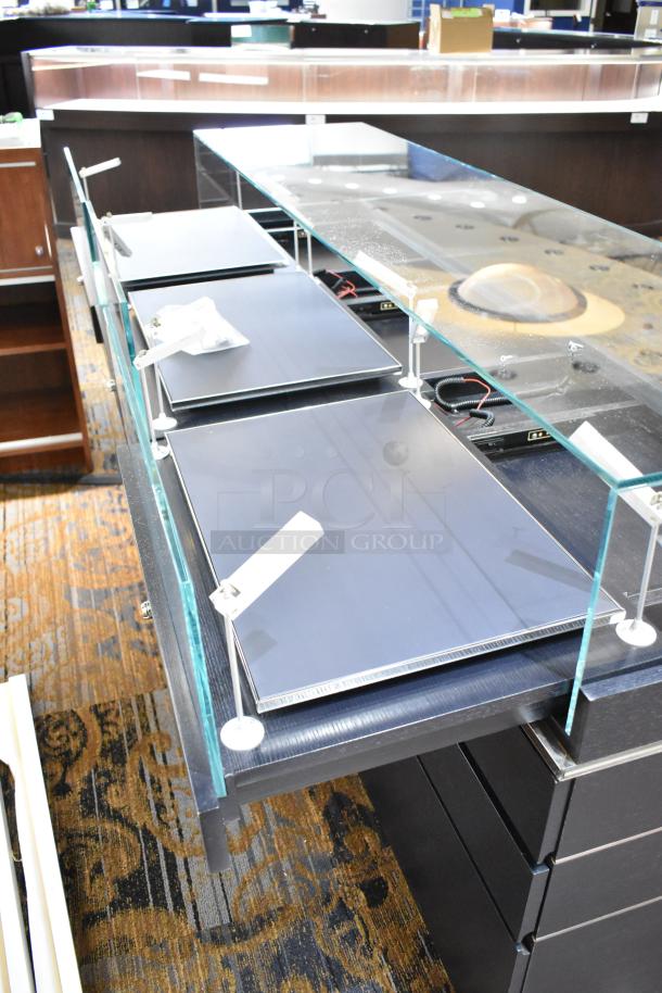 Jewelry display case with six rear drawers, glass top, and black finish. Buyer must remove; bring tools and manpower.
