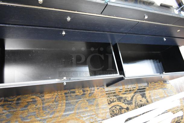 Black jewelry case with glass top, features six rear drawers. Good condition, requires tools and manpower for removal.