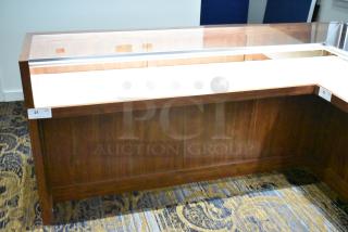 Wooden lighted jewelry case with glass top and two rear doors, excellent condition. Buyer must bring tools for removal.