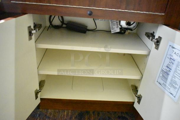 Wooden lighted jewelry case with two rear doors, showing interior shelves and electrical components. Some labels visible.
