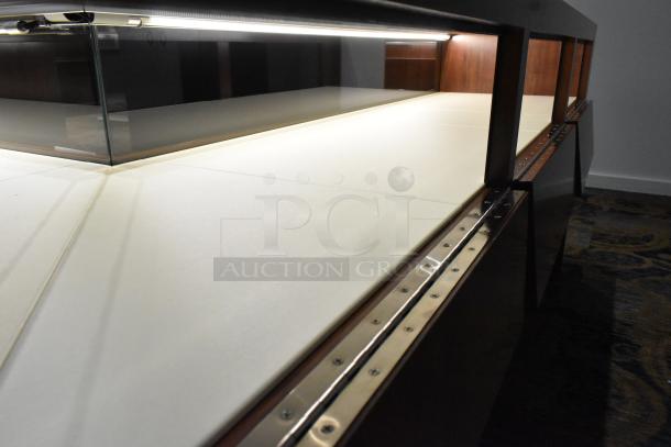 Wooden lighted jewelry case with glass top, two rear doors, and sturdy metal frame. Excellent condition.