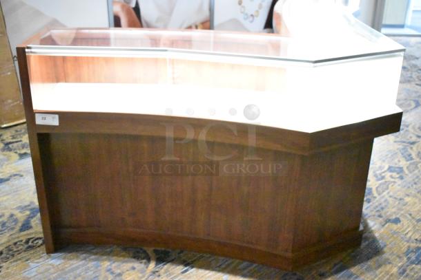 Wooden lighted jewelry case with glass top, four rear doors, excellent condition. Removal tools and manpower required.