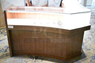 Wooden lighted jewelry case with glass top, four rear doors, excellent condition. Removal tools and manpower required.