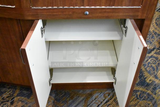 Wooden lighted jewelry case with four rear doors, open to show shelves; excellent condition, requires removal by buyer.