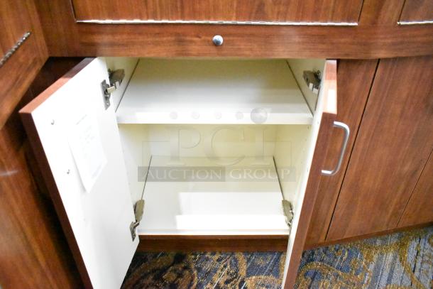 Wooden lighted jewelry case with single open cabinet door, visible shelf, and side panels. Good condition. Buyer to remove.