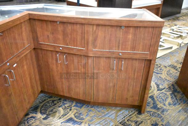 Wooden lighted jewelry case with four rear doors, sturdy condition, glass top, metal handles. Removal tools required.