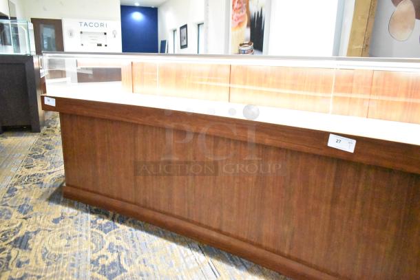 Lighted wooden jewelry display case with glass top, two rear sliding doors, excellent condition; buyer must remove.