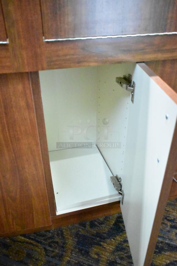 Lighted wooden jewelry display case with two rear sliding doors, open cabinet view, sturdy condition. Buyer removal required.