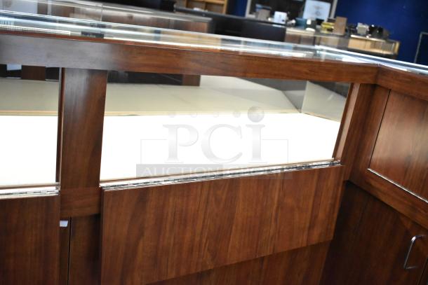 Lighted wooden jewelry display case with two rear sliding doors, excellent condition. Buyer must remove; bring tools and manpower.