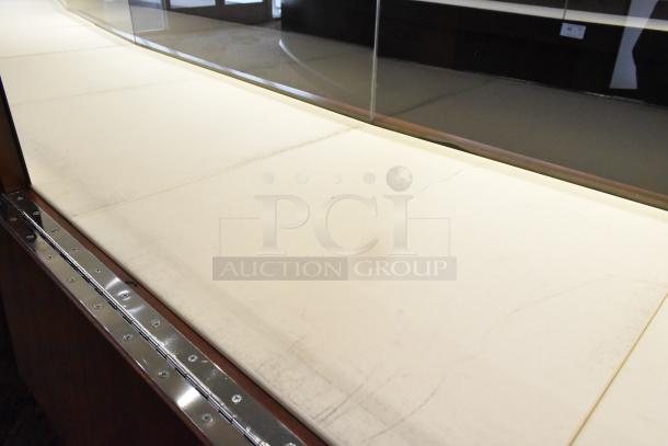 Lighted wooden jewelry display case with two rear sliding doors, white interior, and metal accents. Buyer to remove.