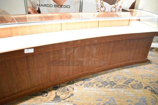 Lighted wooden jewelry display case with 6 rear doors, 3 drawers, glass top. Good condition. Buyer must remove.