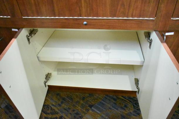 Lighted wooden jewelry display case with 6 rear doors, 3 drawers, and shelving. Good condition; buyer must remove.