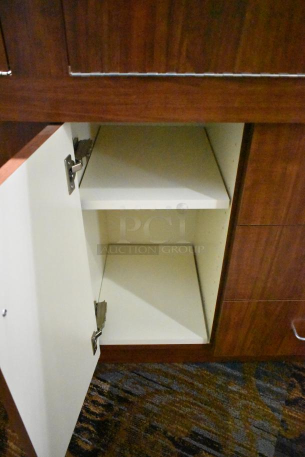 Lighted wooden jewelry display case with 6 rear doors and 3 drawers, features open compartment, bring tools to remove.