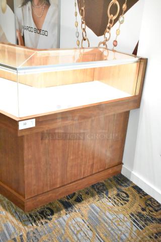 Lighted wooden jewelry display case with two rear doors, glass top, excellent condition. Removal requires tools and manpower.