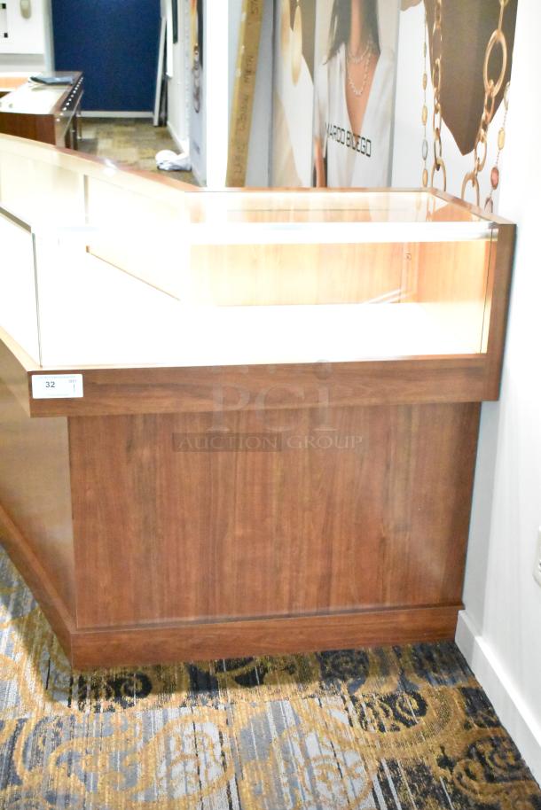 Lighted wooden jewelry display case with glass top, two rear doors, excellent condition. Buyer must remove. Lot 32, Qty 1.