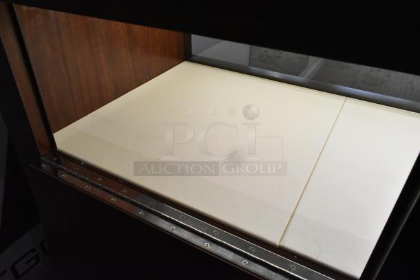 Lighted wooden jewelry display case with two rear doors, showcasing wood finish and interior lighting. Tools required for removal.