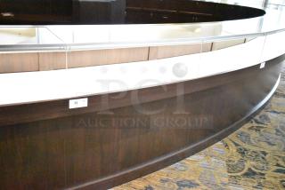 Curved wooden jewelry display case with lighting, rear doors, and drawers. Bring tools for removal. Item tag 33 visible.