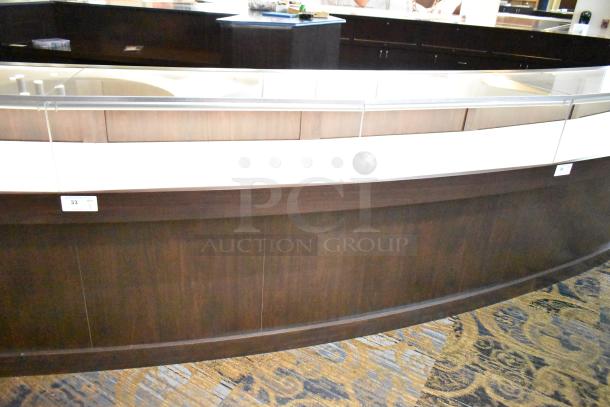 Curved wooden jewelry display case with lighting, rear doors, and drawers. Tags visible: Item 33, Qty 1.