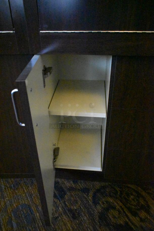 Lighted curved wooden jewelry display case with rear doors and drawers, storage shelves visible, requires removal tools.