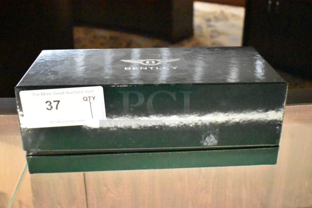 Boxed Bentley Continental GT Gray Minichamp model, marked "37" from PCI Auctions. Original packaging with Bentley logo.