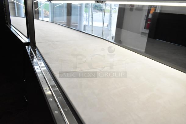 Wooden lighted jewelry case, featuring 3 rear doors and 3 drawers, excellent condition, bring tools for removal.