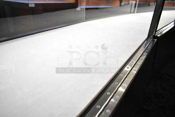 Wooden lighted jewelry case with three rear doors and three drawers. Requires tools and manpower for removal.