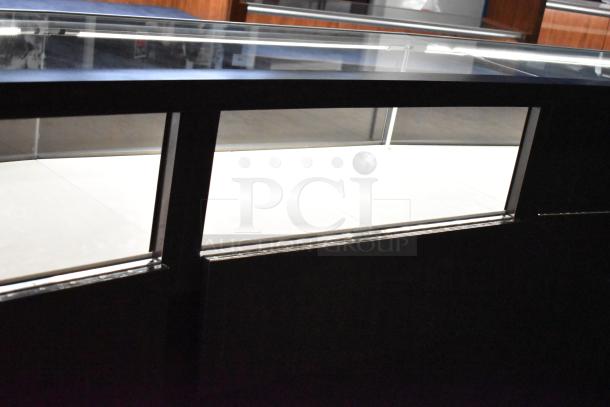 Wooden lighted jewelry case with 3 rear doors and 3 drawers, glass top, excellent condition. Buyer must bring tools for removal.