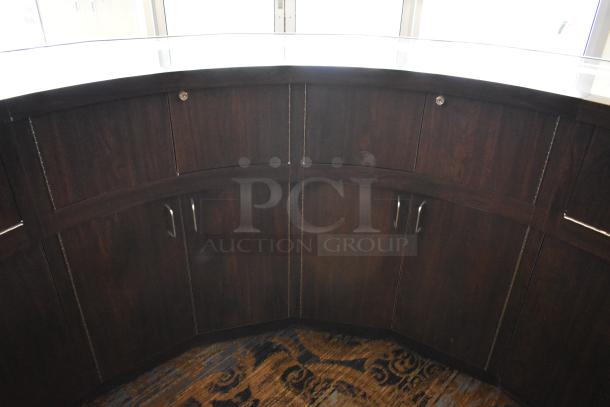 Curved wooden jewelry case with built-in lighting and four rear doors, in good condition. Removal requires tools and manpower.
