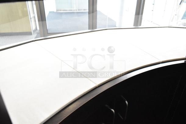 Curved wooden jewelry case with lighting, four rear doors, excellent condition. Buyer must remove with tools.