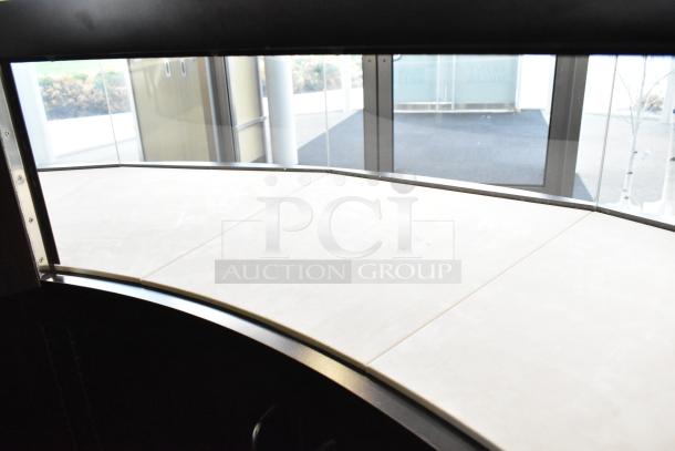 Wooden curved lighted jewelry case with 4 rear doors. Buyer must remove. Ideal for display, needs tools and manpower.