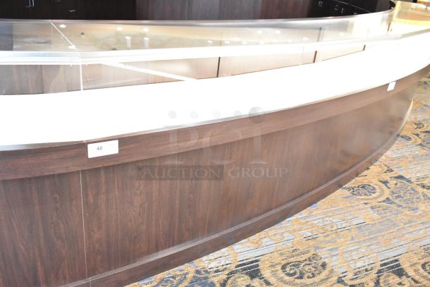 Wooden lighted jewelry case with 3 rear doors and 3 drawers, dark wood finish, glass top, item tag "40". Removal required.