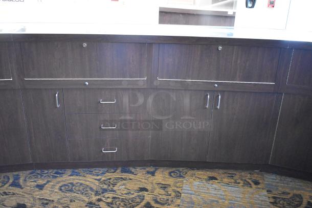 Wooden lighted jewelry case with three rear doors and three drawers. Dark finish, metal handles. Buyer removal required.