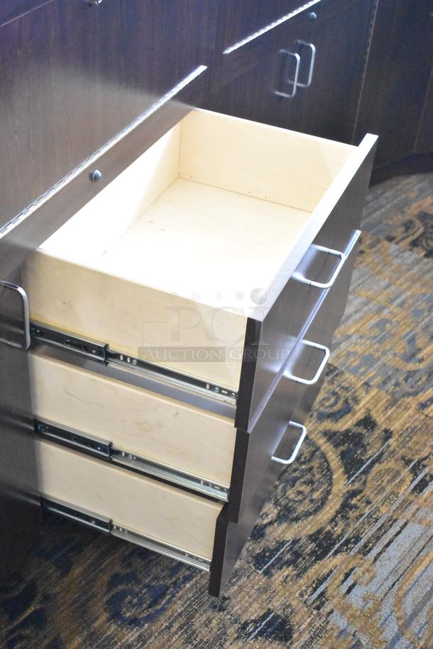 Wooden lighted jewelry case with 3 rear doors and 3 drawers. Dark finish, modern handles. Buyer must remove.