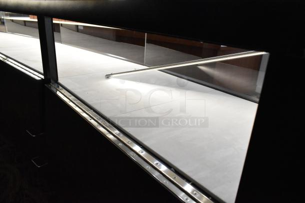 Wooden lighted jewelry case with 3 rear doors and 3 drawers. Buyer must remove. Includes lighting fixtures.