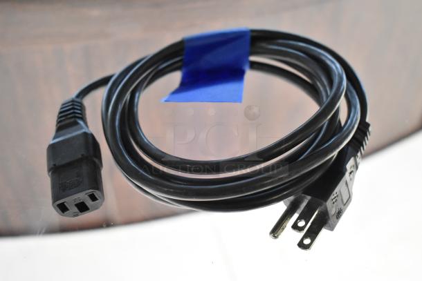 A coiled black power cord with a standard plug, secured with blue tape, likely for an ultrasonic cleaner.