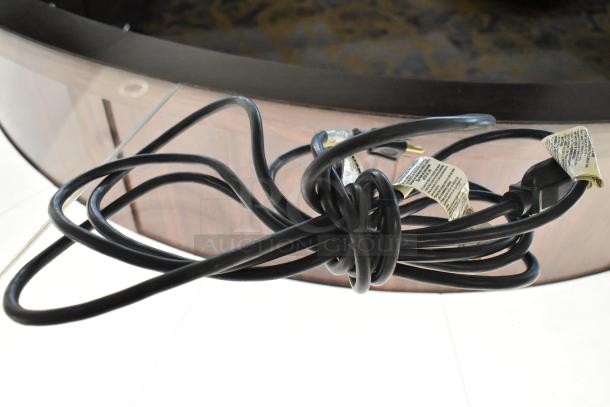 Coiled power cord for Gesswein Elmasonic S30H ultrasonic jewelry cleaner, 115-120 volts, with visible label instructions.