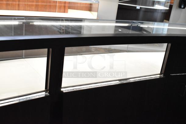 Wooden lighted jewelry case with glass top, featuring four rear doors. Excellent condition, removal tools needed.