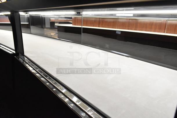 Wooden lighted jewelry case with four rear doors, glass display, and metal trim. Requires tools for removal.