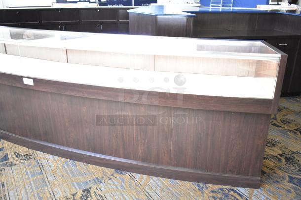 Wooden lighted jewelry case with three rear doors and three drawers, glass top, excellent condition. Bring tools for removal.