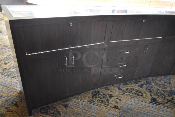 Wooden lighted jewelry case with 3 rear doors and 3 drawers, black finish, glass top. Tools and manpower needed for removal.