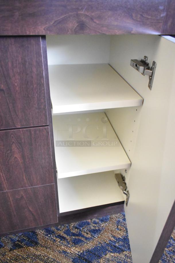 Wooden lighted jewelry case with three rear doors, three drawers. Dark wood finish. Buyer removes. Bring tools.