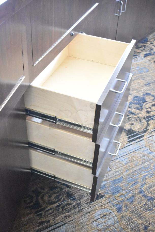 Wooden lighted jewelry case with three rear doors and three pull-out drawers. Good condition. Buyer removal required.