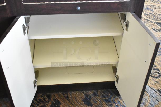 Wooden lighted jewelry case with four rear doors, open front doors visible. Needs tools and manpower for removal.