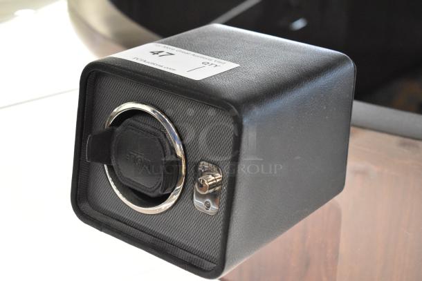 Wolf M2.5 Single Winder 4524029MAY, black leather, chrome accents, visible Wolf logo, pristine condition, auction tag shown.